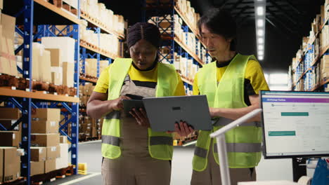vertical video team of diverse workers handling tracking software for parcel status on tablet