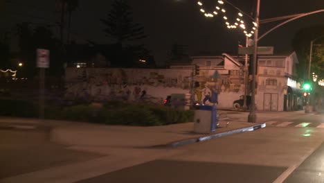 A-Car-Travels-Along-A-Street-At-Night-In-Santa-Monica-California-As-Seen-Through-The-Rear-Window-At-An-Angle-2