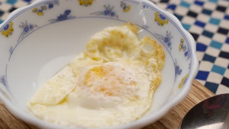 Fried-eggs-in-the-plate-close-up-,,