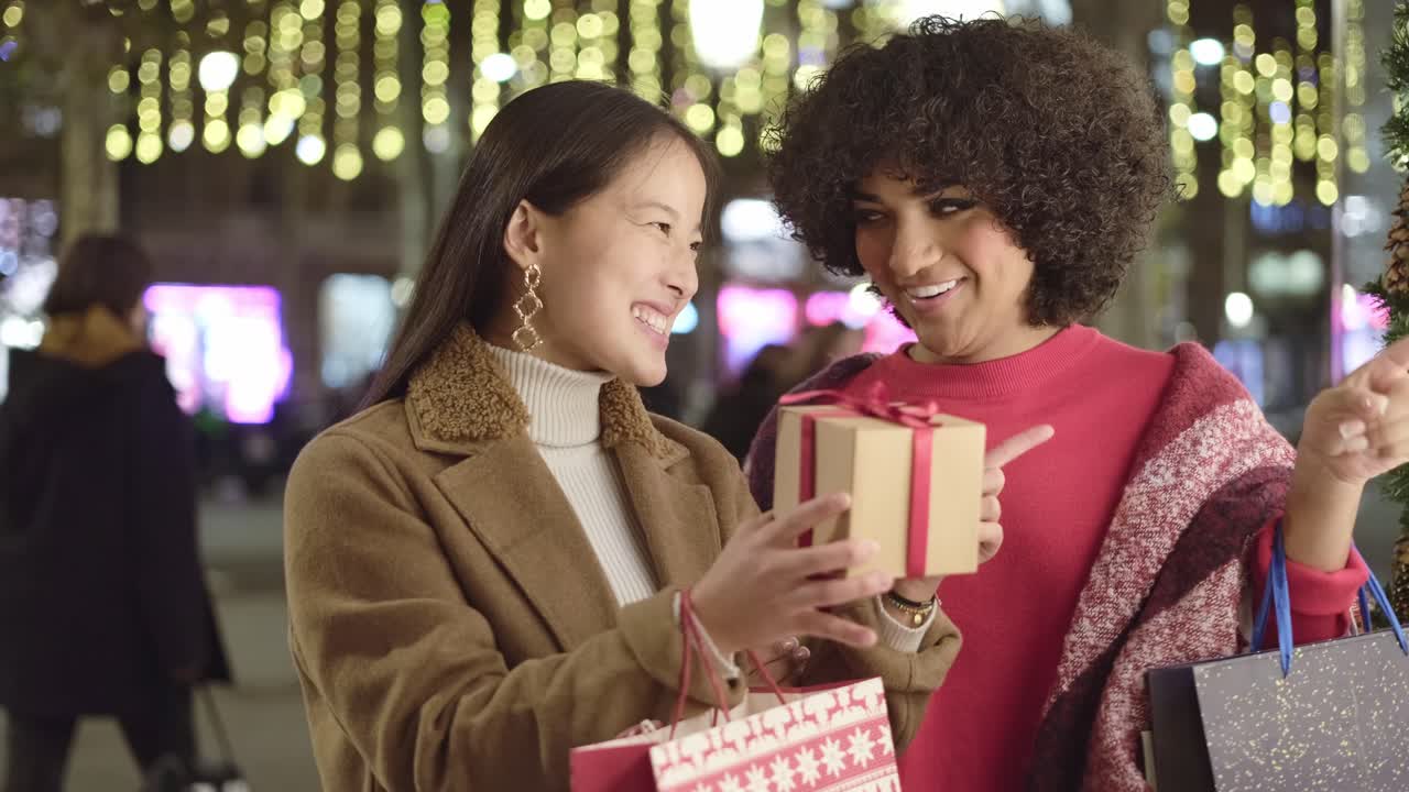 Women Shopping for Christmas Gifts at Night
