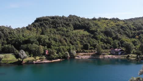 man flying a drone near a river next to his motorhome