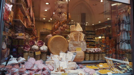 italian deli display with cheese, meats and grocery items