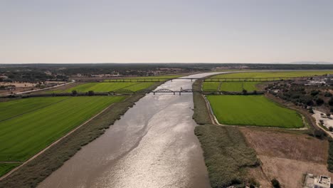 bridges over sado river and beautiful green agricultural fields, alcacer do sal, portugal