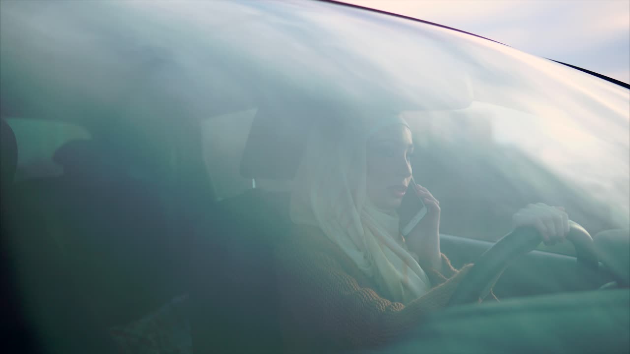 Woman Driving a Car While Talking on a Phone