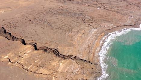 aerial view of dead sea sinkholes and arid coastline