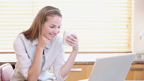 a housewife watching a video on a laptop