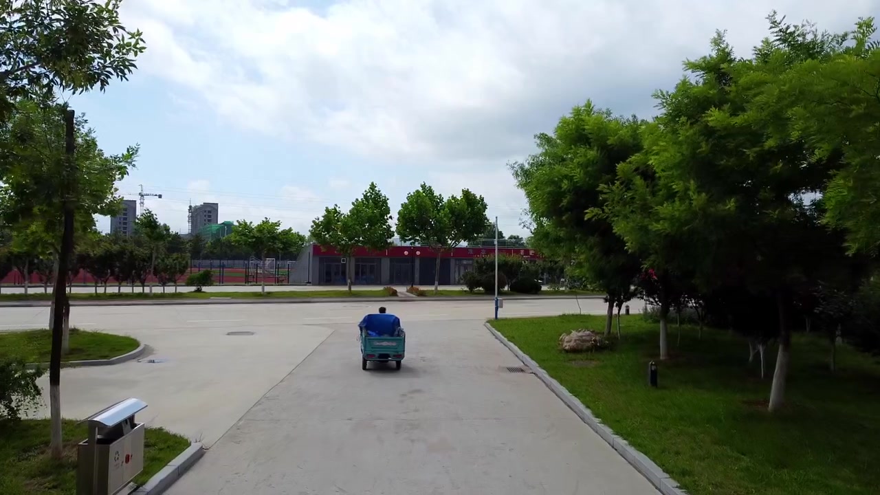 Following electric tricycle driving on empty road in Beijing Jiaotong university (BJTU) campus