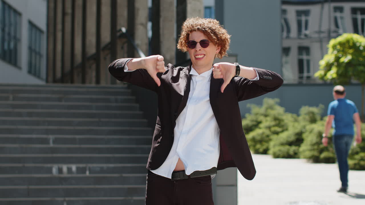 Businessman showing thumbs down sign gesture expressing discontent disapproval dissatisfied mistake