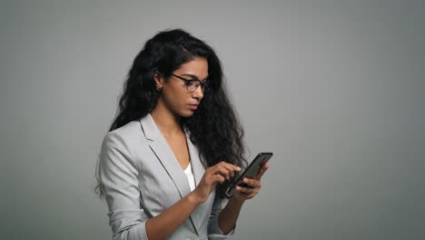 Formally-dressed-young-African-woman-uses-a-phone