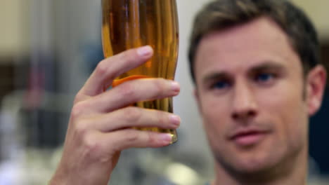 Brewery-worker-checking-the-product