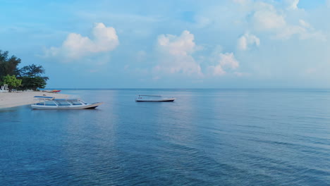 Tropical-paradise-beach-at-early-morning-with-fishing-boats-in-calm-waters