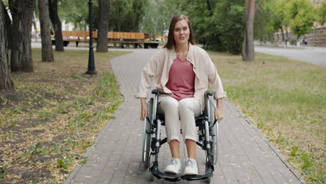 woman in wheelchair enjoying a park stroll