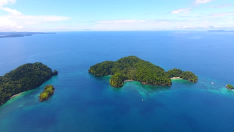 high above isla afuera, a small secluded island that is part of a panamanian archipelago on a beautiful summer day in paradise