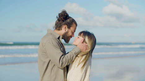 caucasian couple standing at seashore