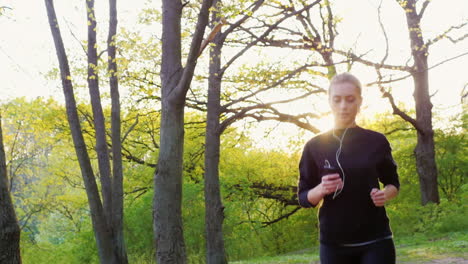 Steadicam-Slow-Motion-Shot-An-Attractive-Young-Woman-Makes-A-Morning-Jog-In-The-Forest-The-Sun-Is-Sh