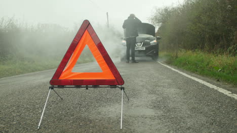 driver broken down calling recovery service on mobile phone