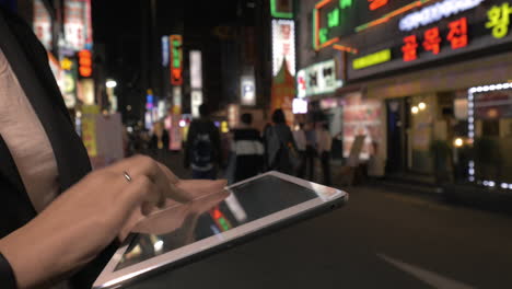 woman with digital tablet in night seoul republic of korea