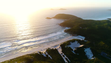 Sunset-over-Squeaky-Beach,-golden-hour-drone