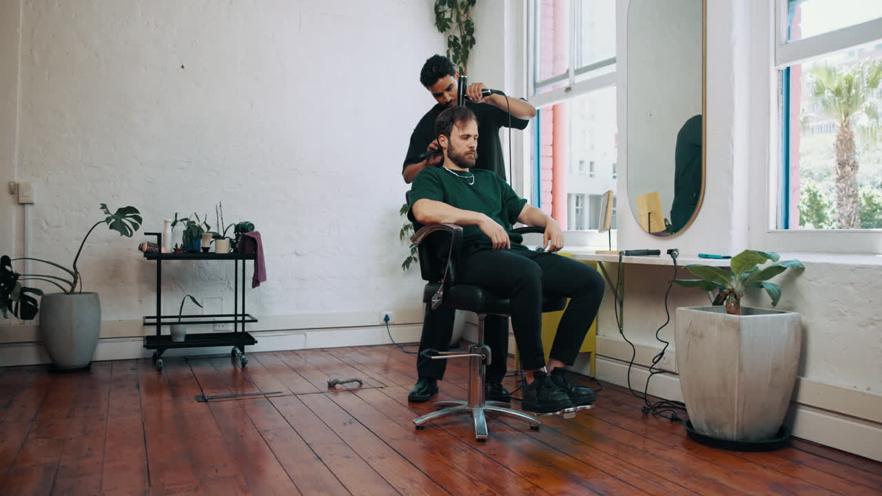 Barber Giving a Haircut to a Male Client in a Modern Barbershop