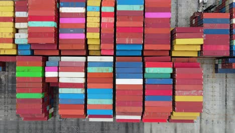 Aerial-view-above-piles-of-colorful-cargo-crates-at-a-dock---overhead,-drone-shot