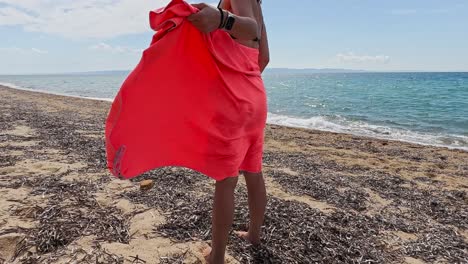 beautiful woman drying herself with a towel on the beach