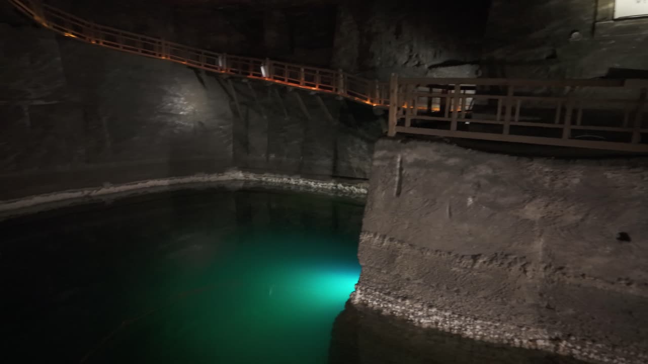 Mysterious underground salt mine pool with wooden walkway, Krakow's Wieliczka