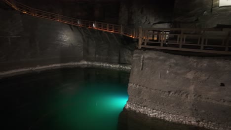 mysterious underground salt mine pool with wooden walkway, krakow's wieliczka