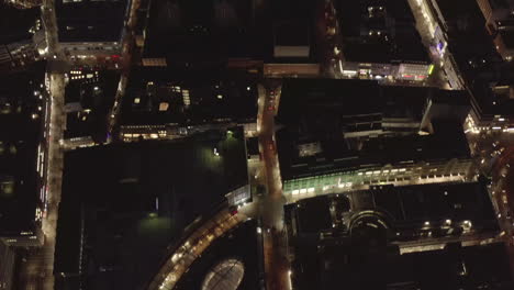 AERIAL:-Slow-Overhead-Shot-of-City-at-Night-with-Lights-and-Traffic,-Cologne,-Germany