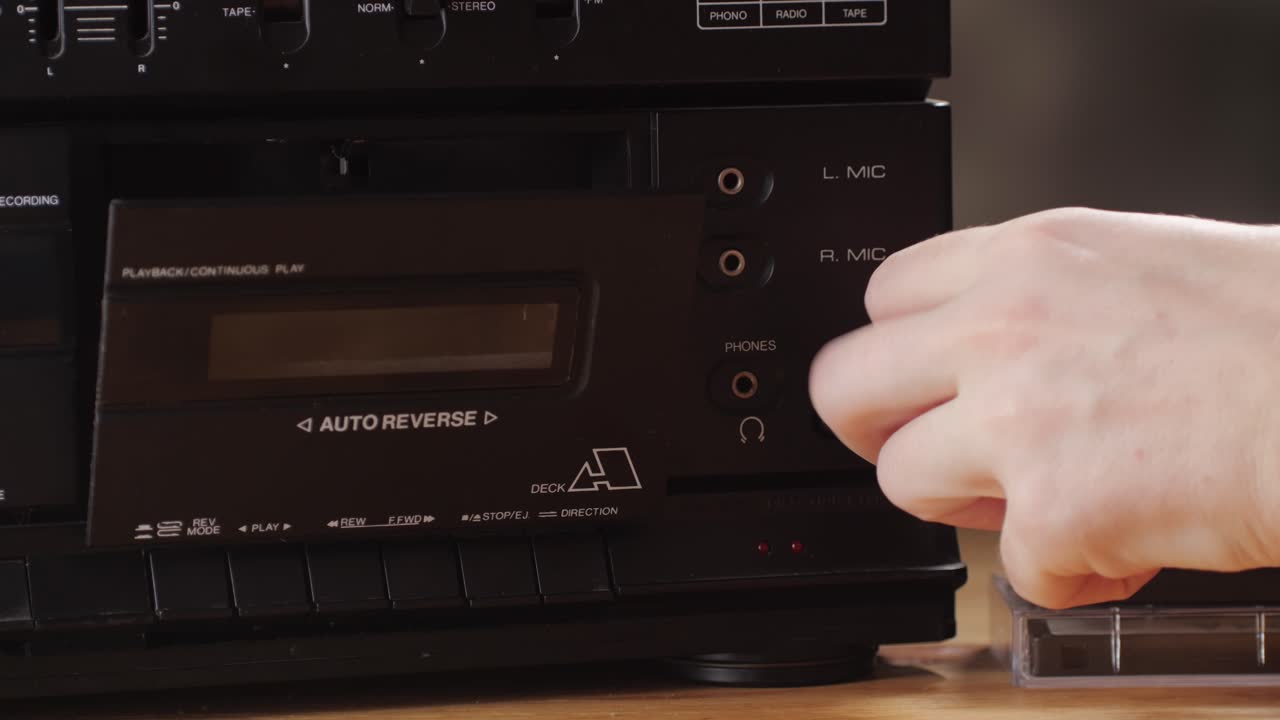 Retro radio tape recorder, audio cassette close-up. Listening to music, old radio boom box player, macro of vintage music listening.