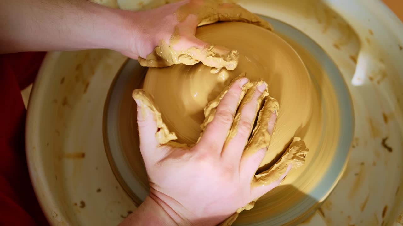 The Art of Pottery: Handcrafting a Unique Bowl on the Wheel with Focused Technique and Skill in a Rustic Ceramic Studio Environment