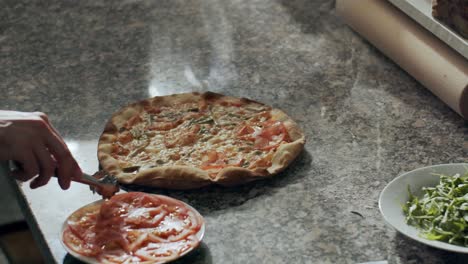preparing vegetarian pizza in restaurant kitchen