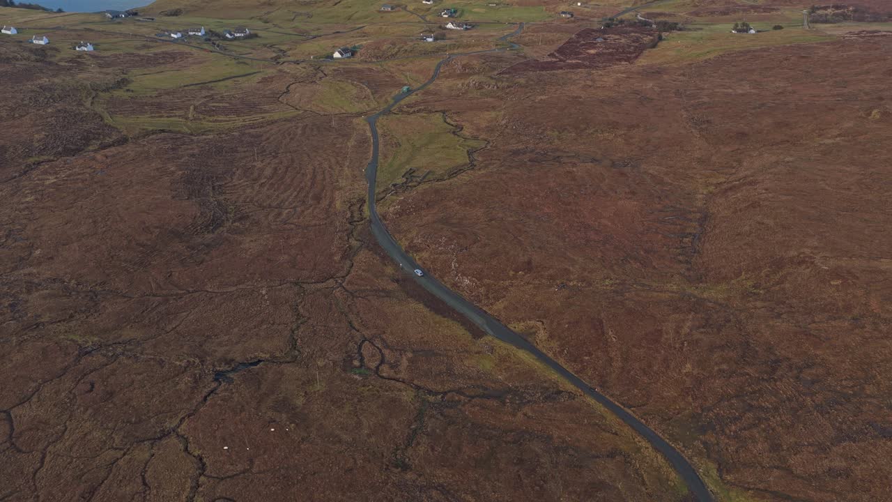 Bil kører på naturskøn vej på Isle of Skye, Skotland