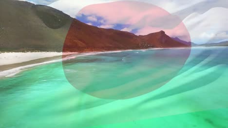 digital composition of waving japan flag against aerial view of waves in the sea