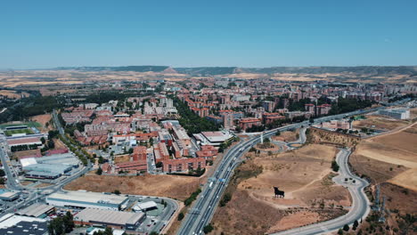 aerial view of a city with a black bull monument