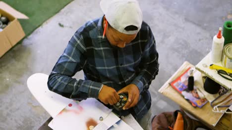 man using spray painting on a paper 4k