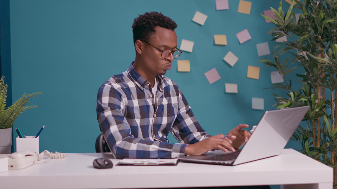 Pensive freelancer brainstorming ideas about work on laptop