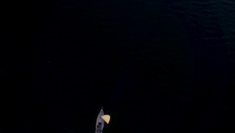 sail boat on lake in the mountains during sunset