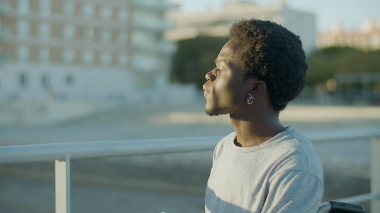 Medium Shot Of Young Man Having Takeaway Coffee In Park