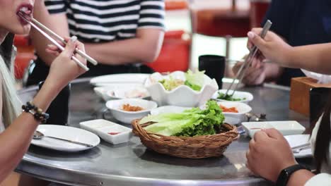 group of friends sharing a meal at a korean bbq