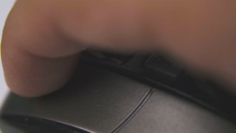 man clicks button on computer mouse in white background