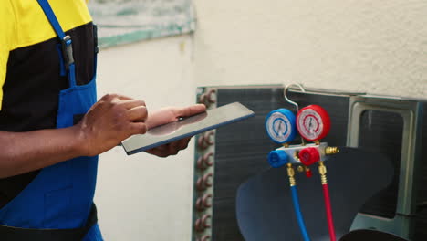 technician inspecting freon levels