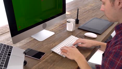 the freelancer male typing with green screen display