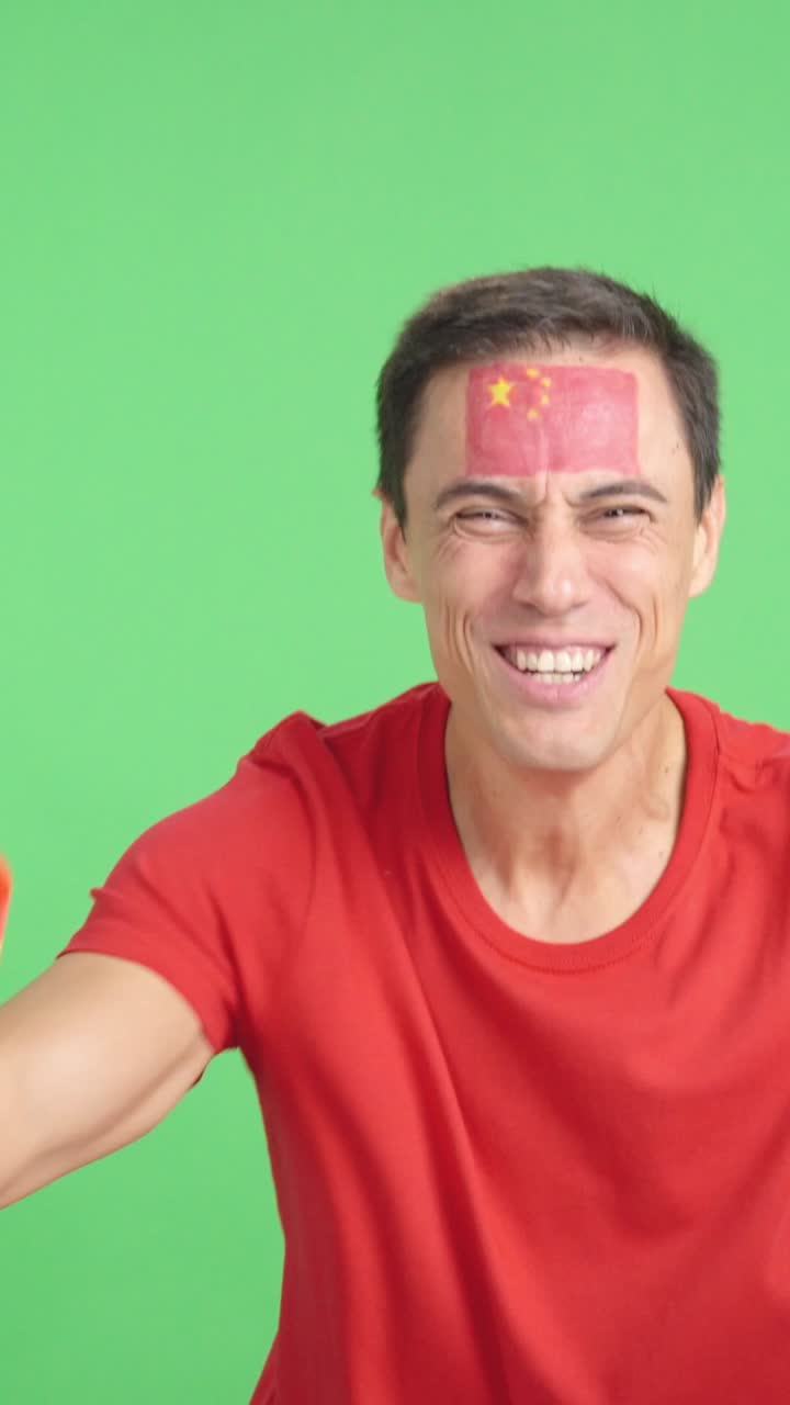 Man cheering for China screaming and waving a national flag
