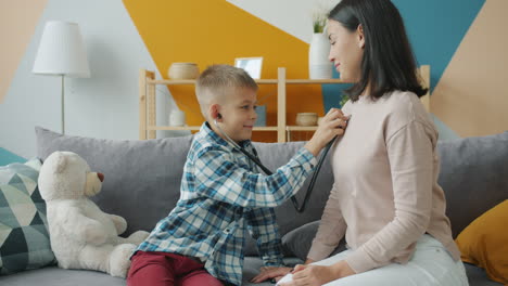mother and son play doctor at home