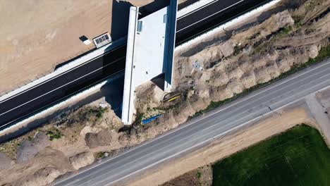 AERIAL---Bridge-in-railroad-construction,-Baden,-Austria,-wide-shot-top-down