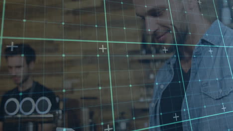 two colleagues standing in modern business office, engaging with teal digital grid interface