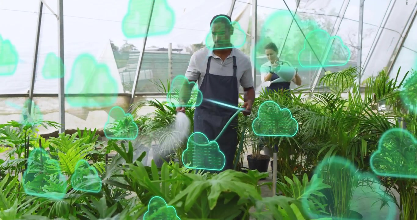 Coworkers watering plants in greenhouse, causing cloud icons appearing around pots for data overlay