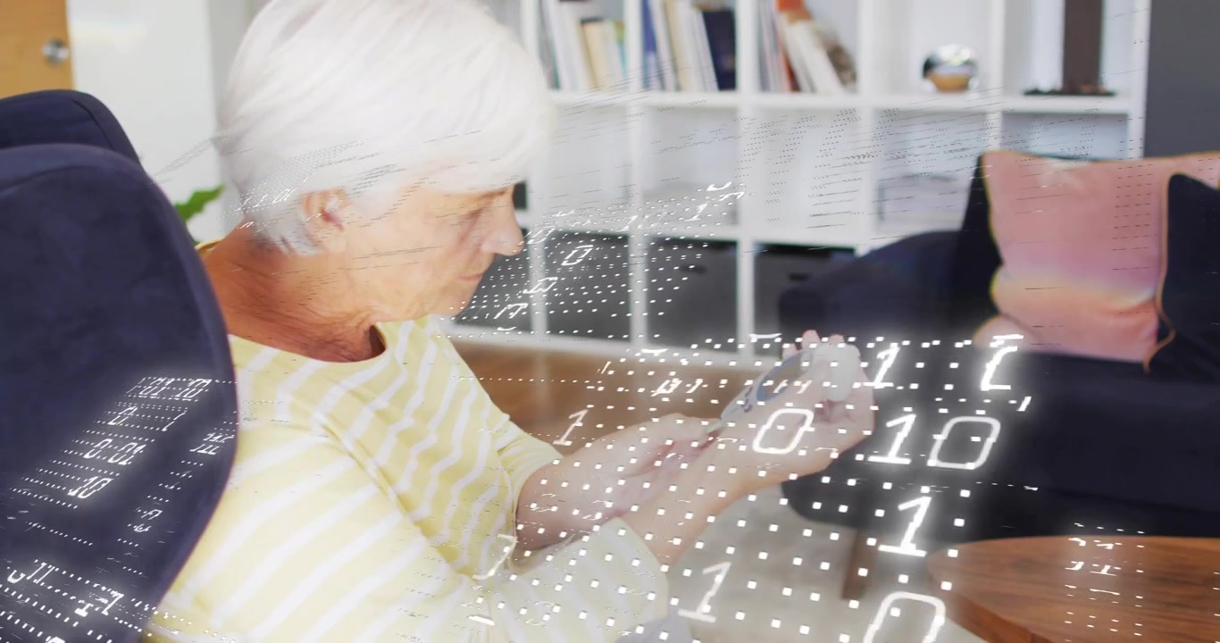 Senior woman tapping health monitor in armchair, creating floating data grid and analyzing data