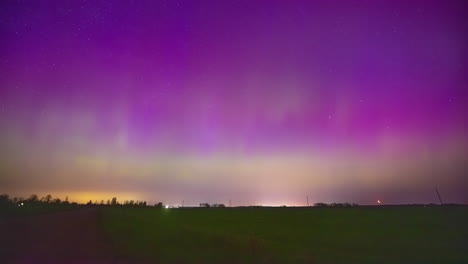 Pink-and-green-color-Aurora-Borealis-on-night-sky,-time-lapse