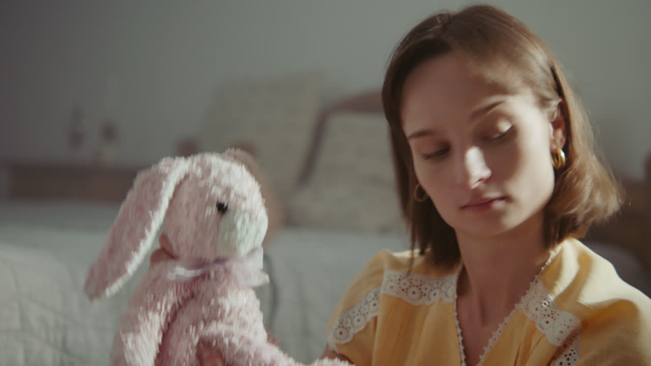 A girl playing with dolls in her room